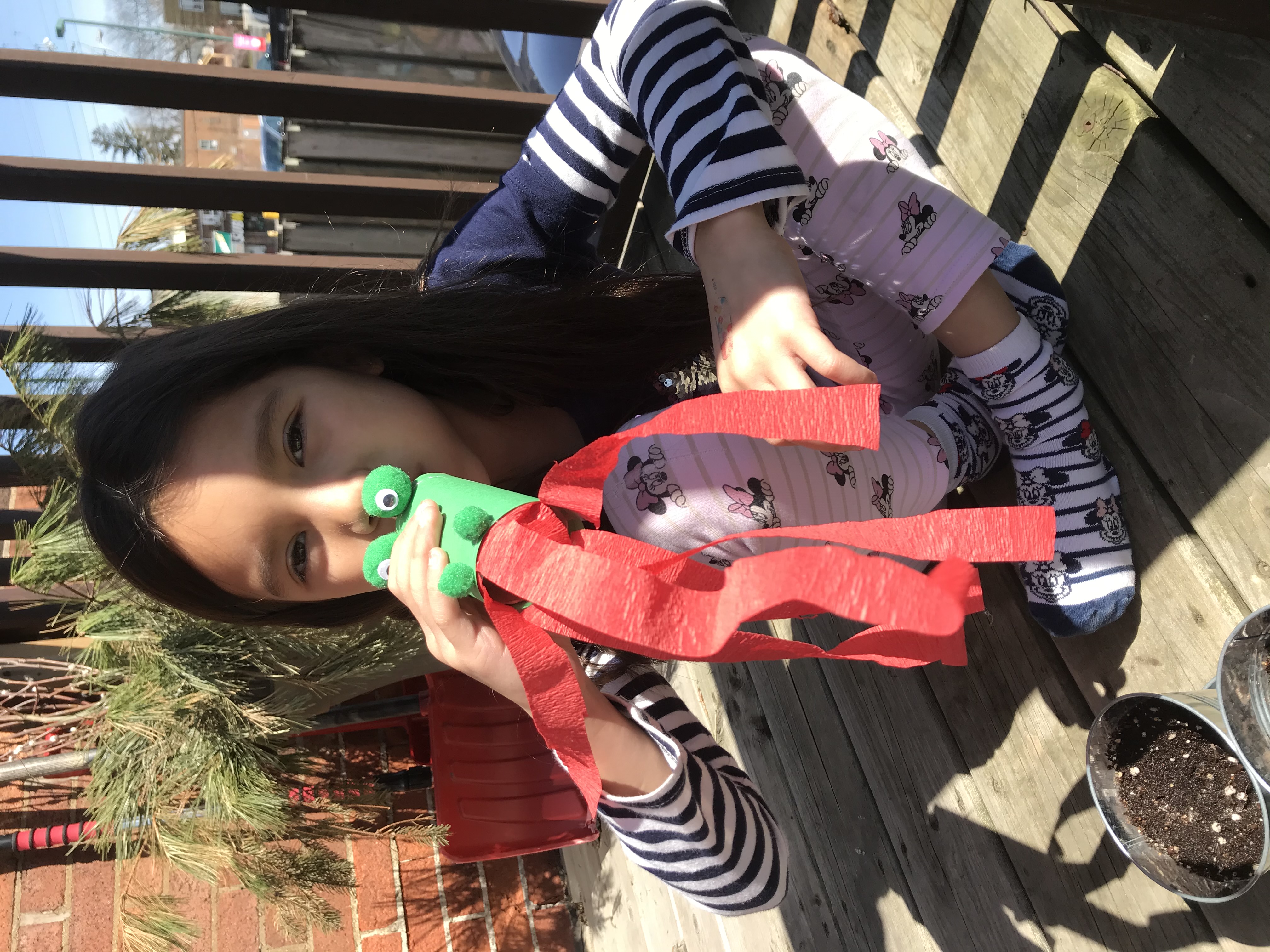 Small hands cutting and building with craft materials